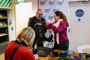 Grainne Hope from Music Health Ireland showing Haptic Vests at The Role of Assistive Technology in Art event. Haptic vents are wearable devices used to translate music into vibrations for Deaf people to engage with music.